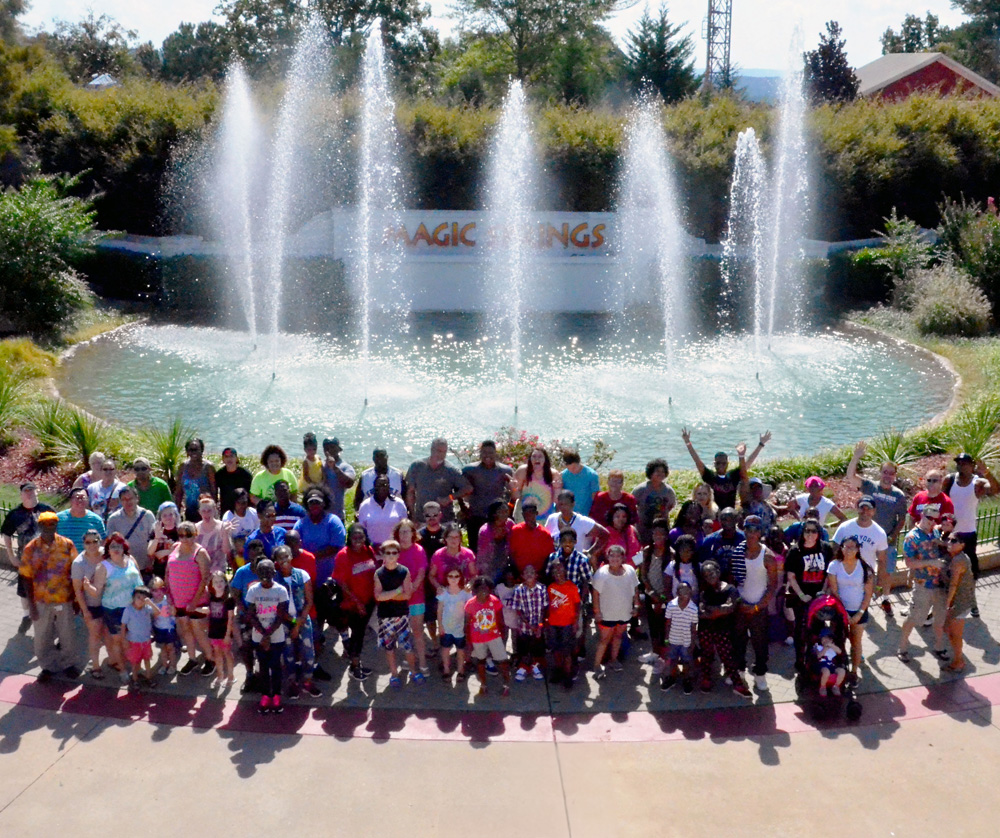 Group enjoying a corporate event posing in front of fountain